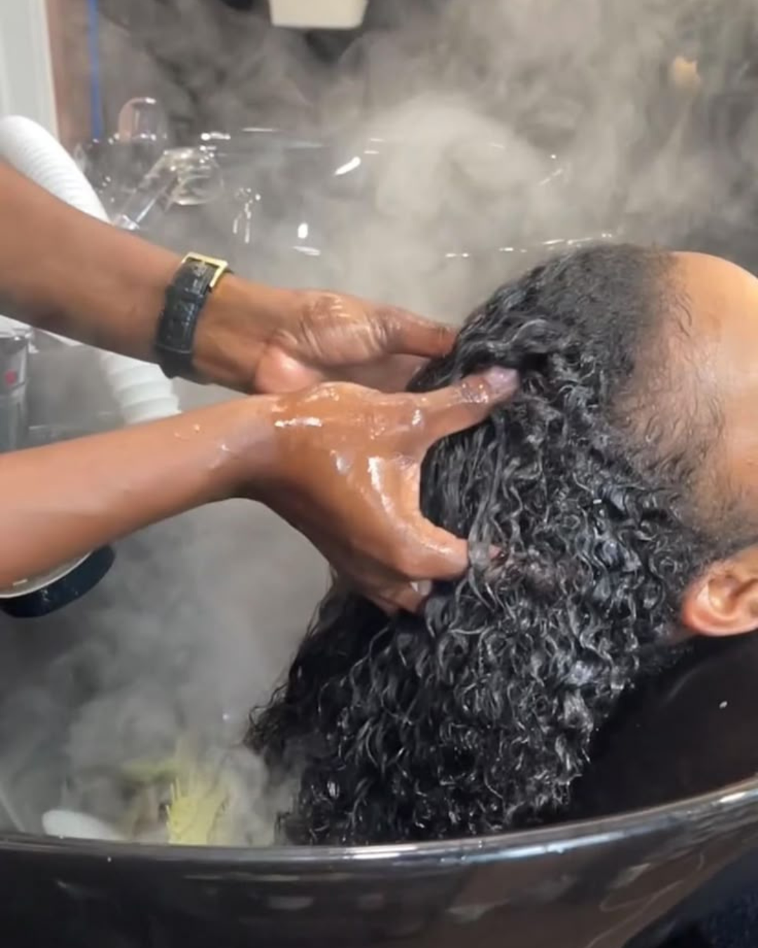 Woman receiving a relaxing hair spa treatment at a professional salon