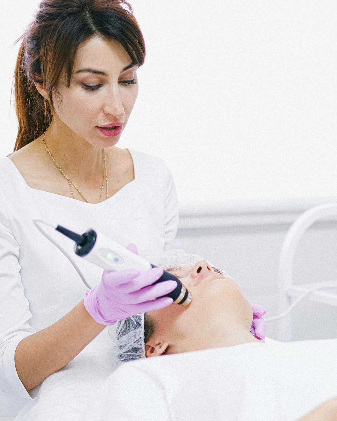 Woman receiving a hydra facial treatment in a beauty parlour